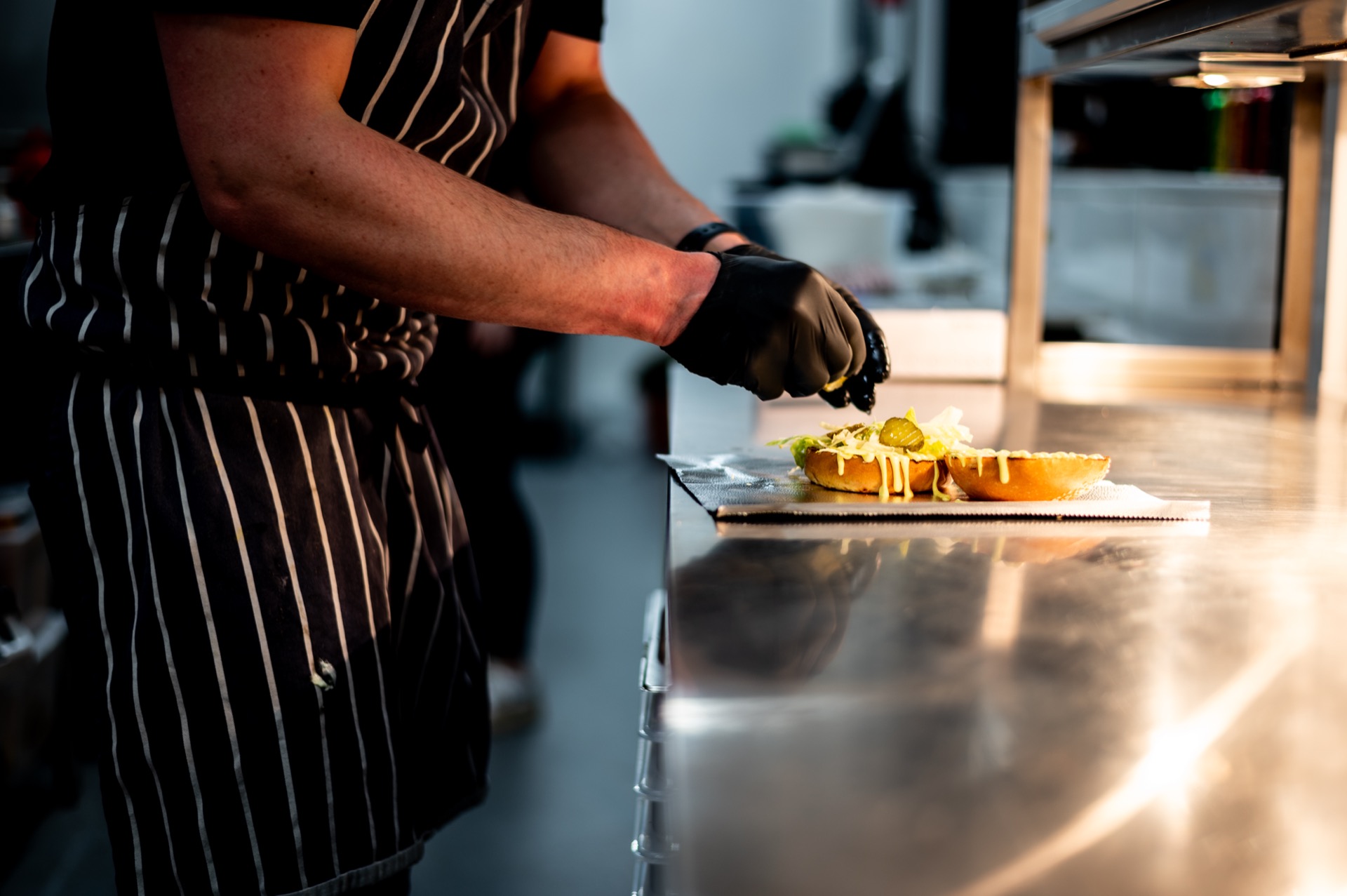 Food prep at STACK — sauce on buns